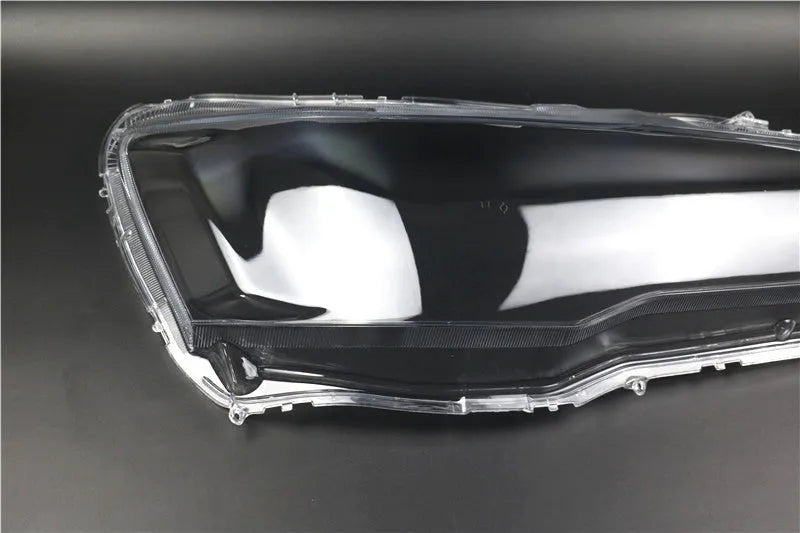Transparent plastic vehicle headlight housing cover showing dimensions.