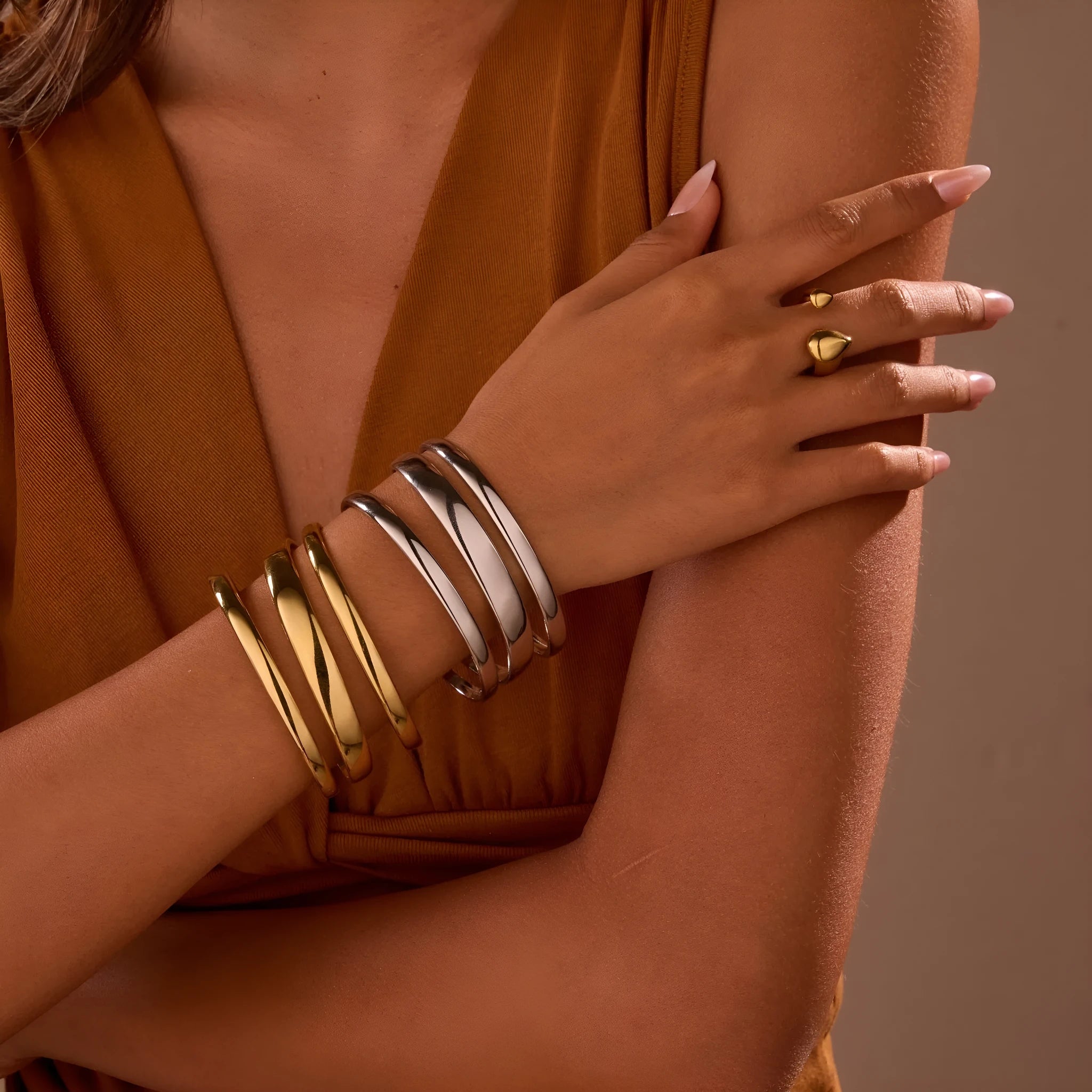 Geometric line design stainless steel women's bracelet with a simple opening clasp, shown in gold and steel colour options.