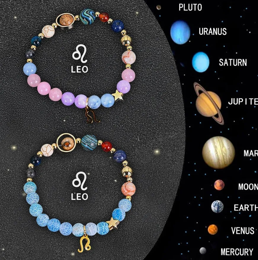 Two adjustable natural stone beaded bracelets with metal zodiac sign charms on a wooden surface.