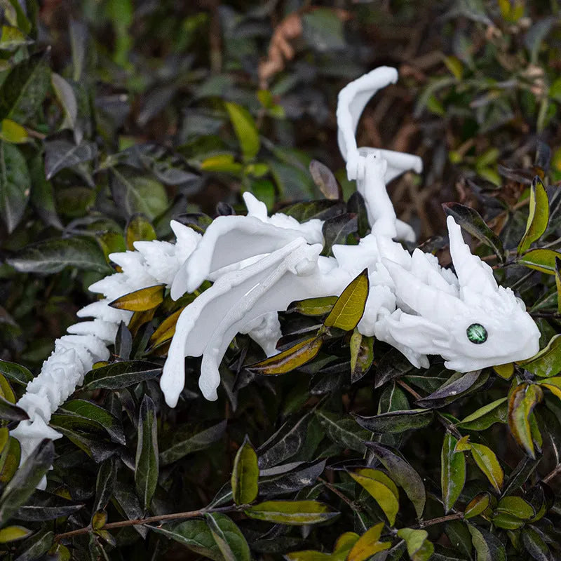 Red and gold 3D printed dragon wings toy decoration on a white background.