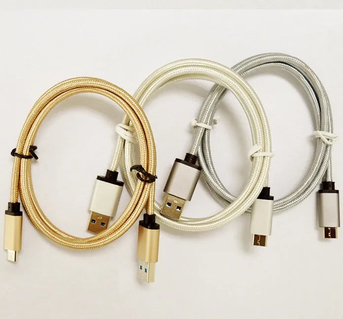 Gold USB Type-C to USB 3.0 braided charging cable with metal plugs on a white background.