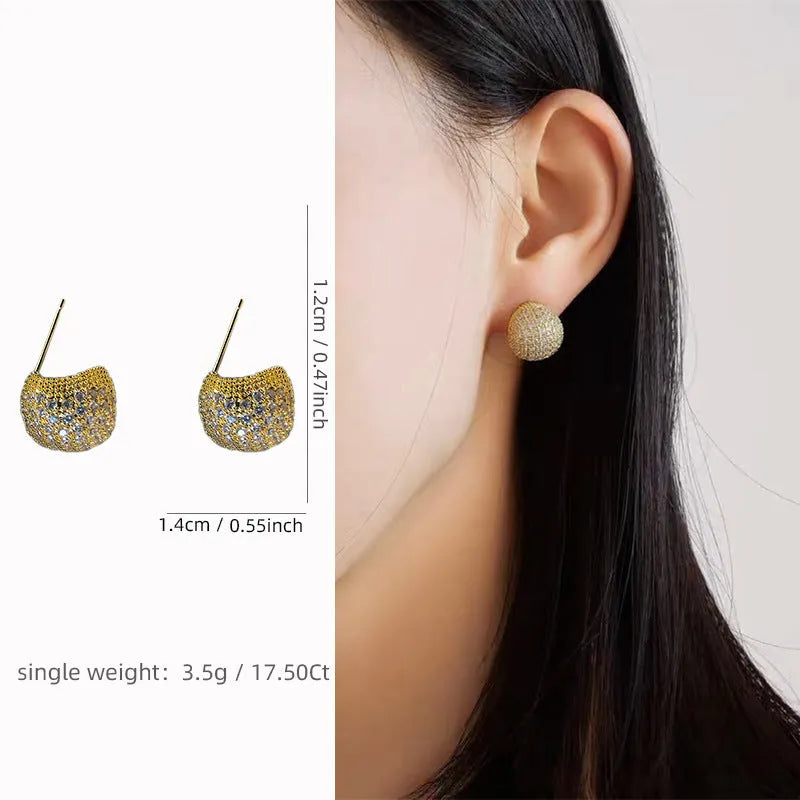Gold and white geometric drop earrings with sparkling diamond-cut bean spheres.
