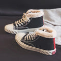 Black women's winter canvas shoes with velvet lining, animal pattern, buckle fastening, low-top rubber sole.