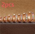 Circle zircon perforated stud earrings in gold, rose gold, and silver colour on a white background.