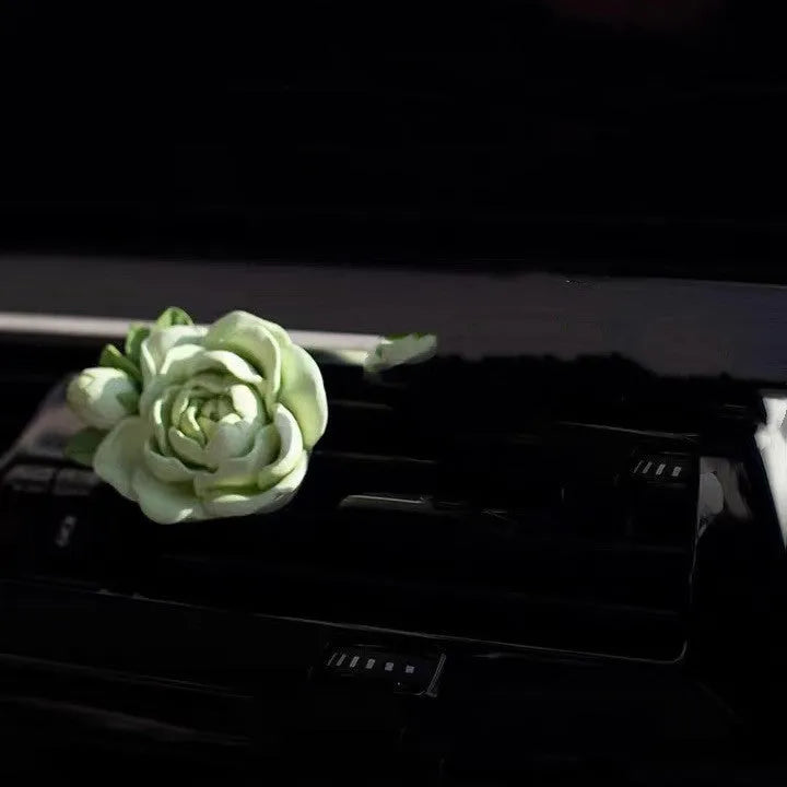 Jasmine scented solid gypsum car air vent diffuser in off white or green.