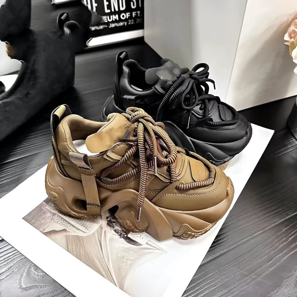 Women's white sneakers with cross straps and a hidden wedge heel on a wooden floor