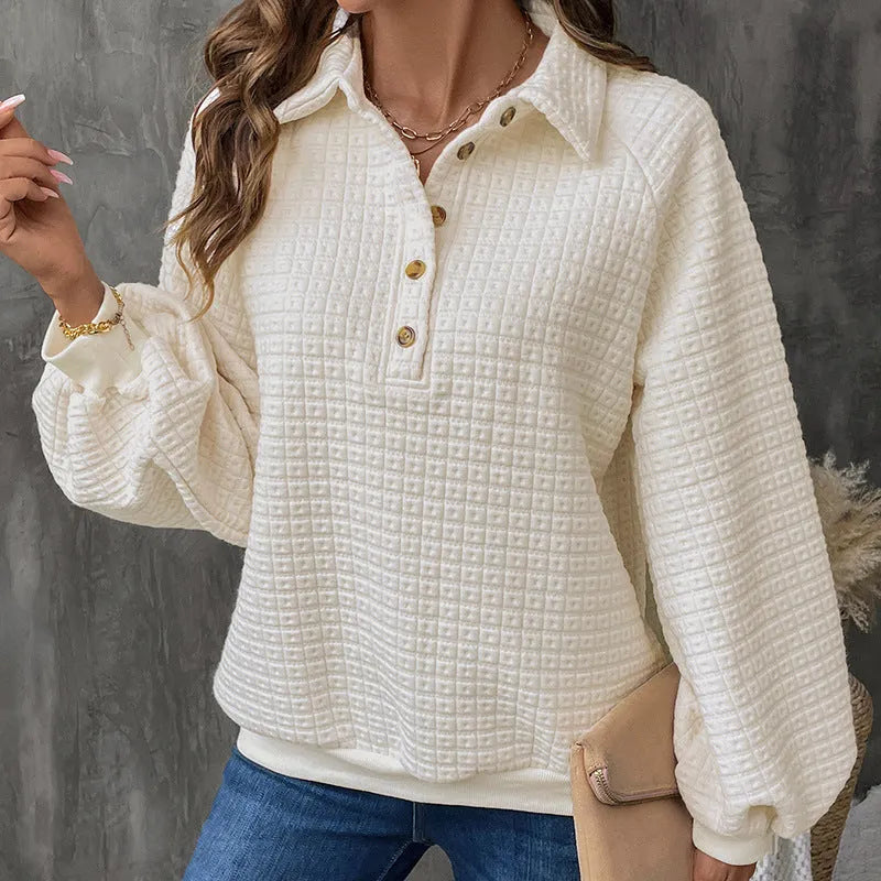 Women's beige textured polo collar long sleeve sweater laid flat.