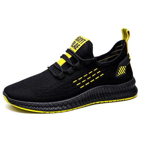 Men's black casual low-top trainers with flying weave upper, cross straps, and a striped pattern.