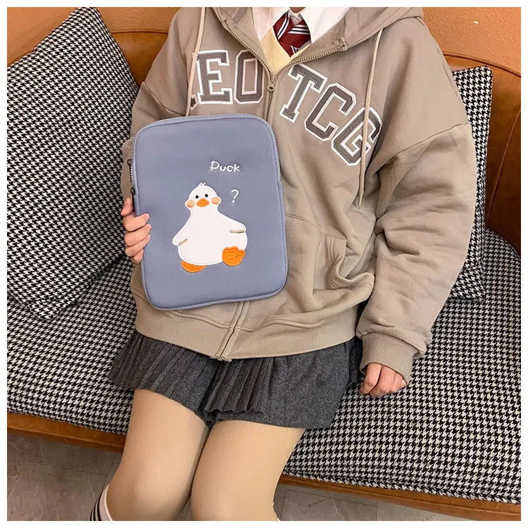 Blue cotton tablet case with embroidered cartoon duck design and a zipper.