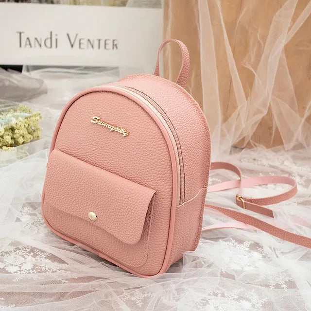 Women's black PU backpack purse with letter design and shoulder strap showing compact 18.5cm length
