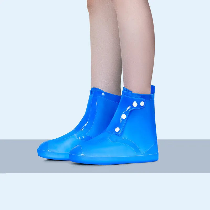 White high top PVC reusable waterproof shoe cover for women, shown on a foot.