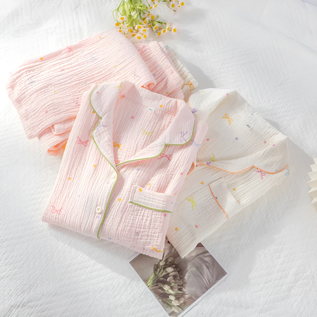 Women's cotton pajama set in pink colour with long sleeves and trousers on hanger