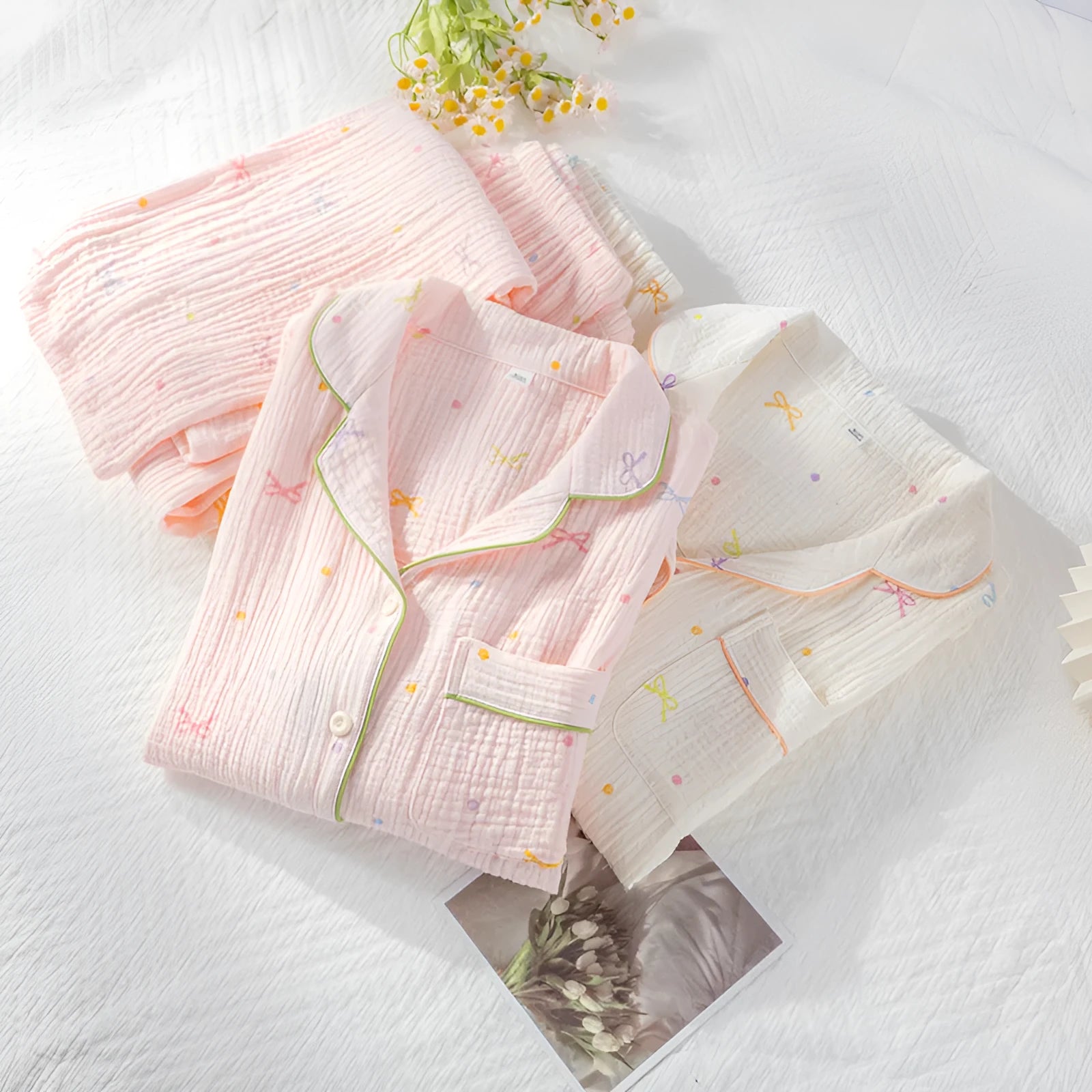 Women's cotton pajama set in pink colour with long sleeves and trousers on hanger
