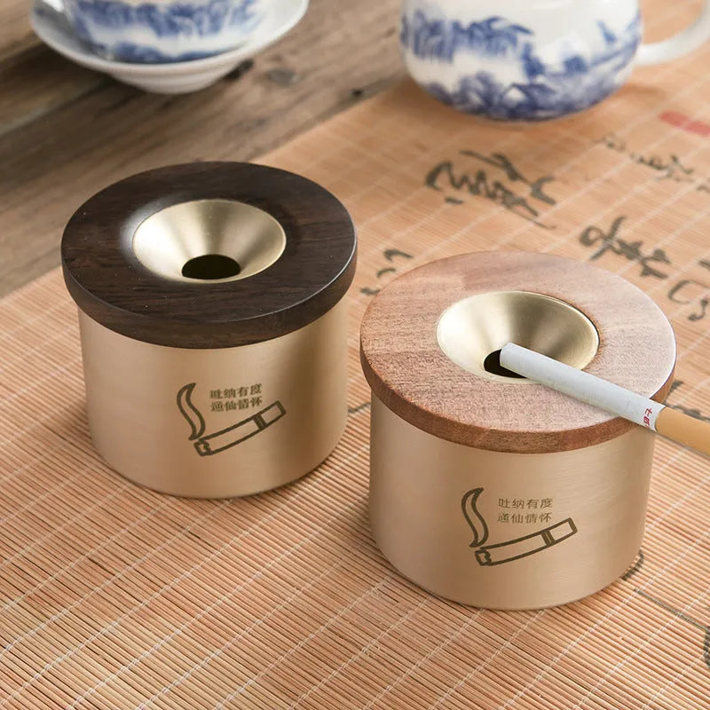 Retro brass ashtray with wooden lid showing copper construction and central hole design