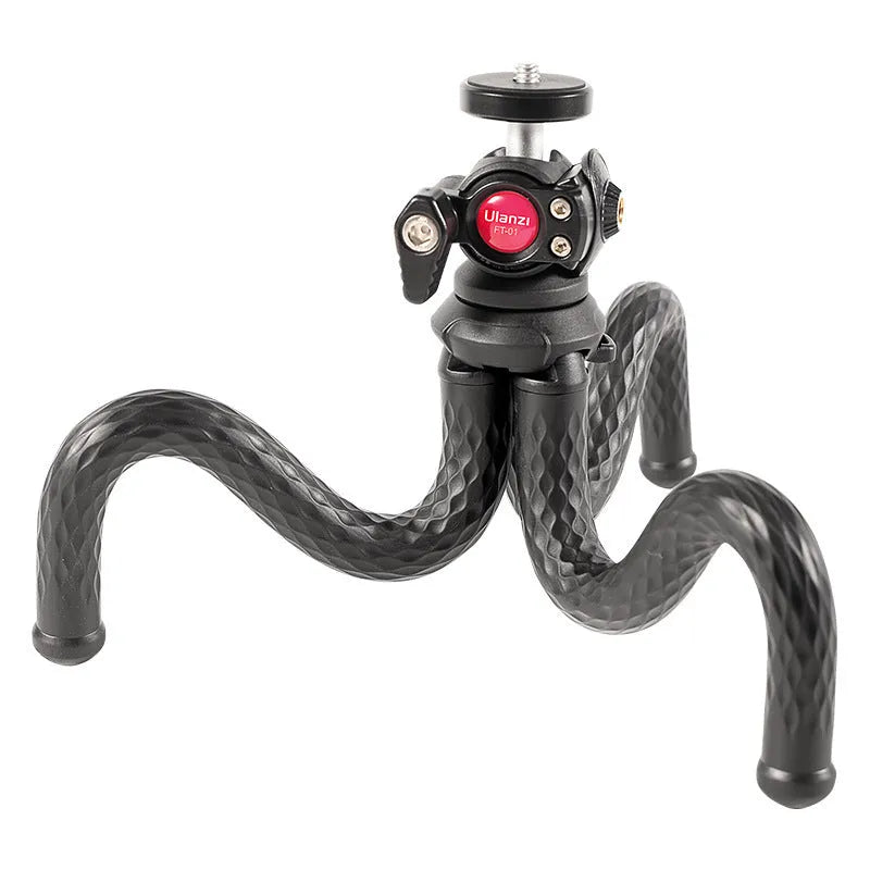 Black octopus tripod with mobile phone clip extended to 360mm length on a table