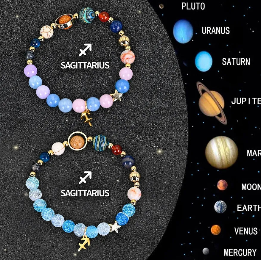 Two adjustable natural stone beaded bracelets with metal zodiac sign charms on a wooden surface.