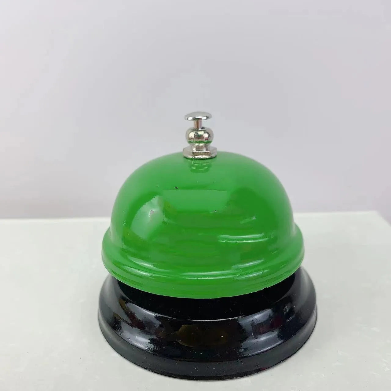 Handheld iron game bell in one of ten colours like red, blue, or green tea, for classroom or restaurant use.