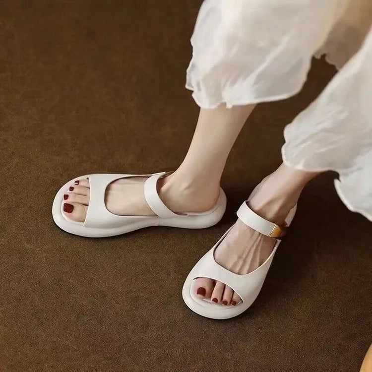 Apricot and white French soft leather peep toe platform sandals with a flat rubber sole.