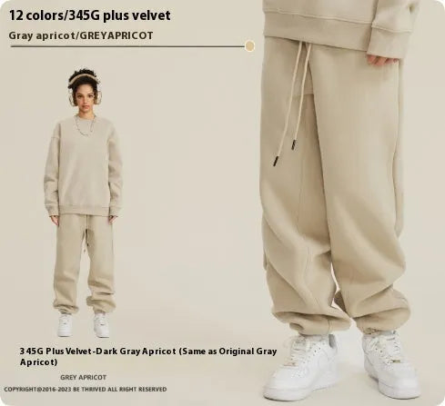Man wearing dark brown velvet sweatpants with an ankle band and elastic waist.