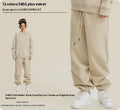 Man wearing dark brown velvet sweatpants with an ankle band and elastic waist.