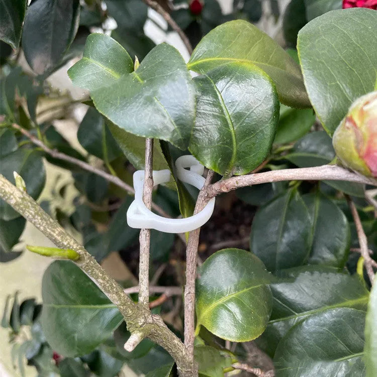 Cat-shaped plastic plant clip in green colour for garden stem support