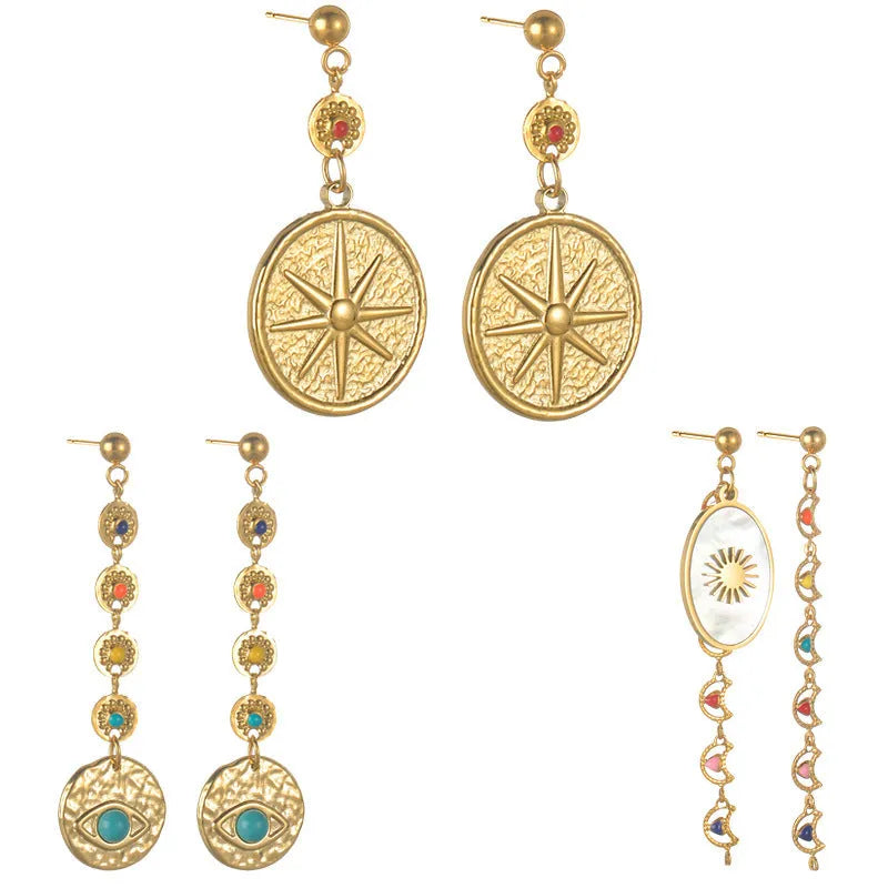 Three pairs of geometric stainless steel stud earrings showing star, eye, and sun designs