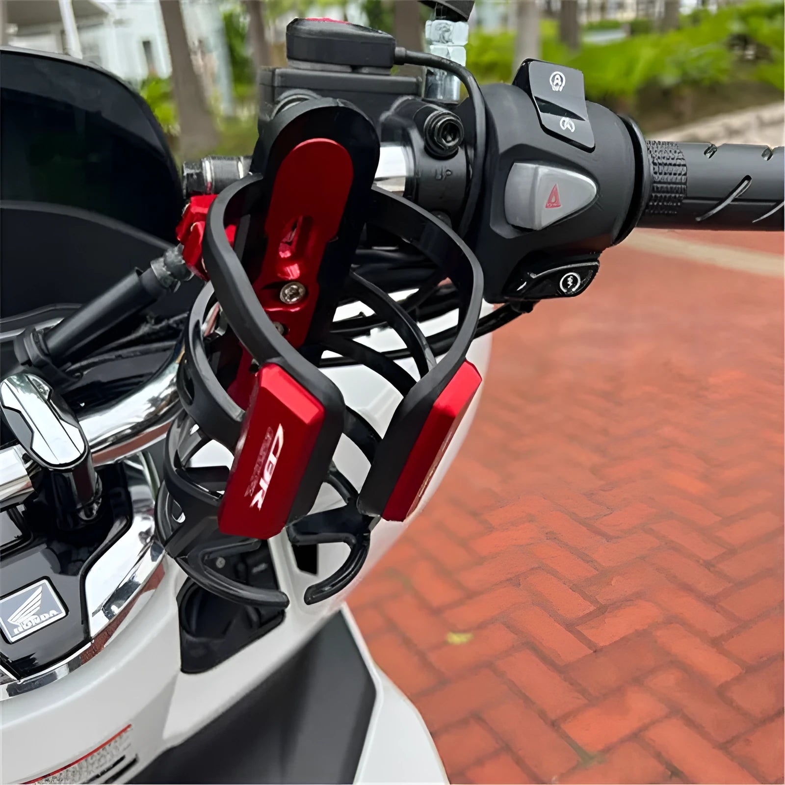 Black water bottle cage mounted on Honda X-ADV scooter for hydration modification