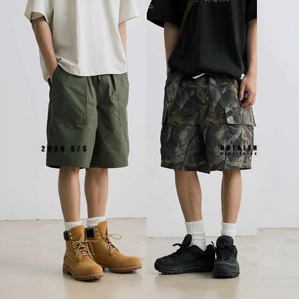 Man's loose straight-leg denim shorts in black on a hanger, showing mid-rise waist and zip fly.