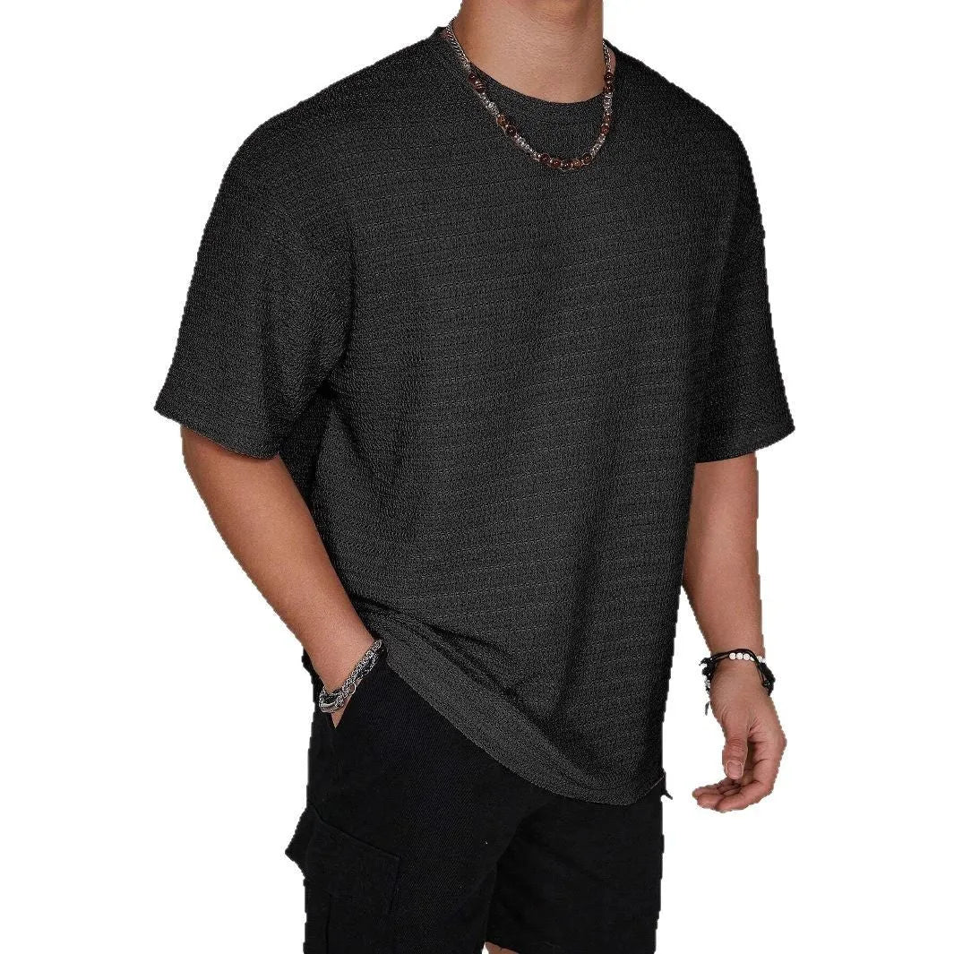 Men's loose fit light blue short sleeve round neck t-shirt on a hanger.