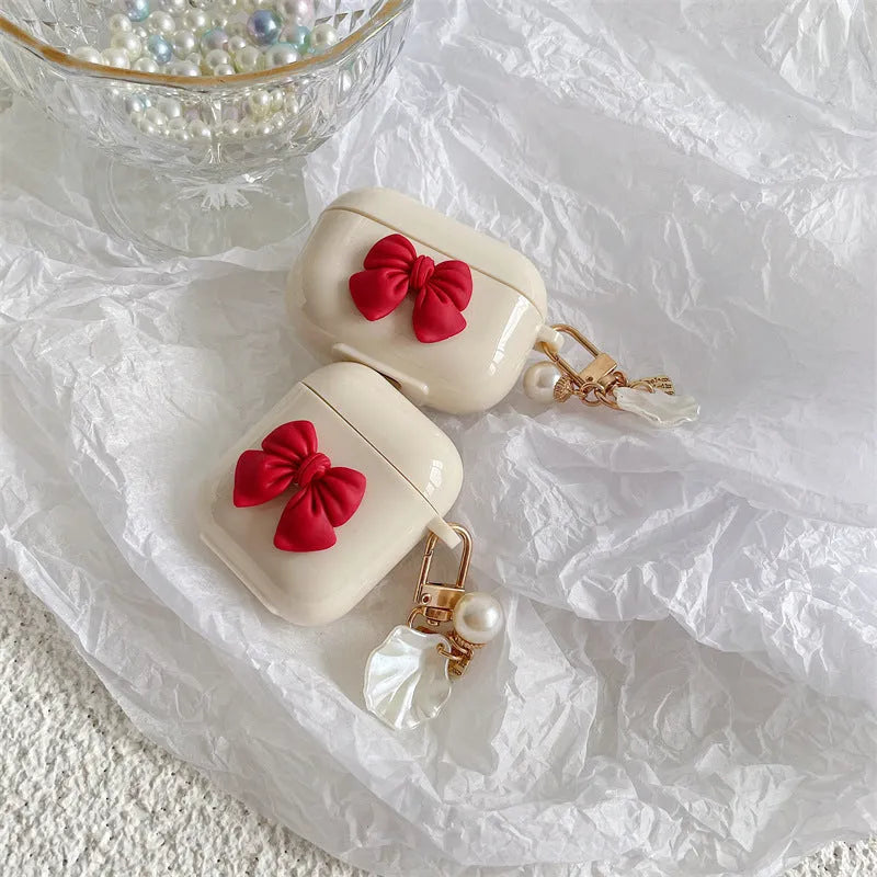 Beige red bow shell TPU AirPods protective case showing clamshell design