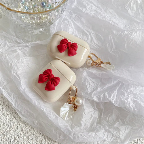 Beige red bow shell TPU AirPods protective case showing clamshell design