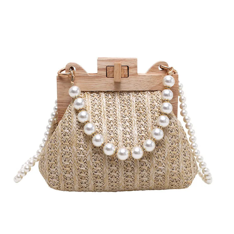 Women's straw woven shoulder bag with pearl chain strap in horizontal square shape showing internal organisers