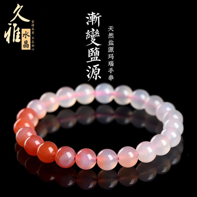 Natural gradient colour agate bracelet with geometric beads on a wrist.