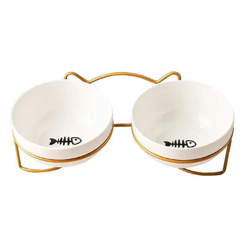 White ceramic cat bowl with decorative pattern sitting in a black iron frame stand.