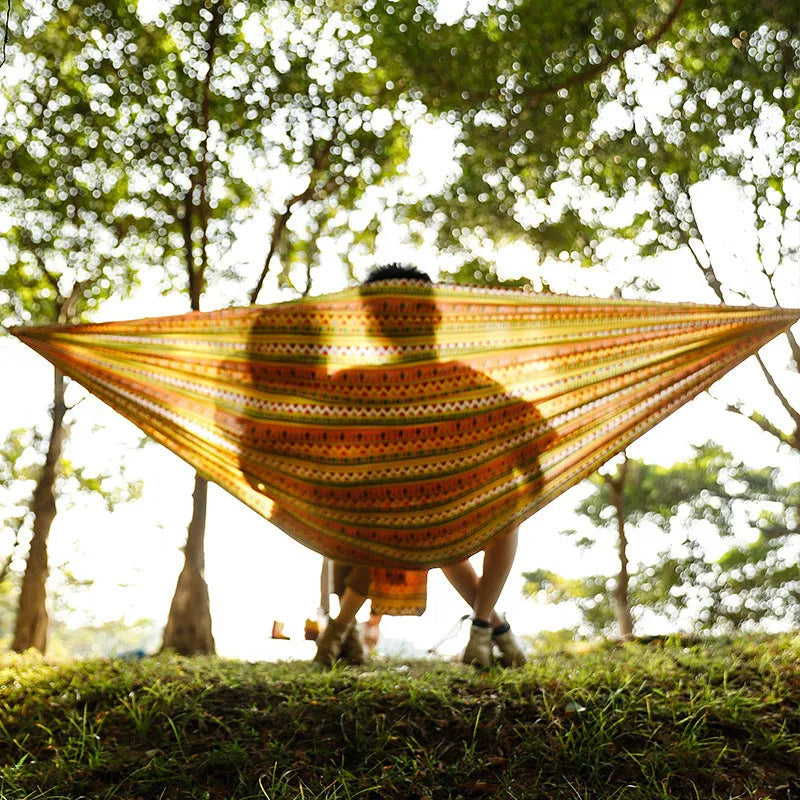Outdoor parachute cloth hammock in bohemian yellow print, laid flat on grass, 260x140cm size