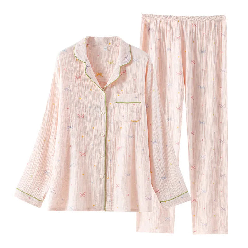 Women's cotton pajama set in pink colour with long sleeves and trousers on hanger