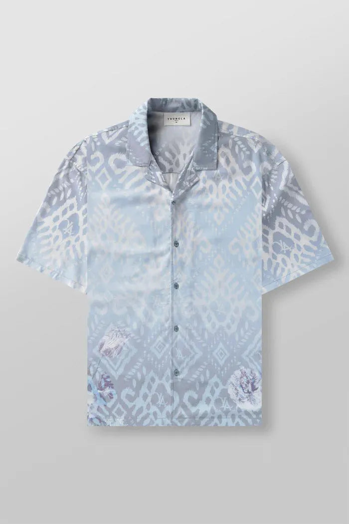 A man's loose-fitting, short-sleeve casual top with a floral print, shown in a light colour.