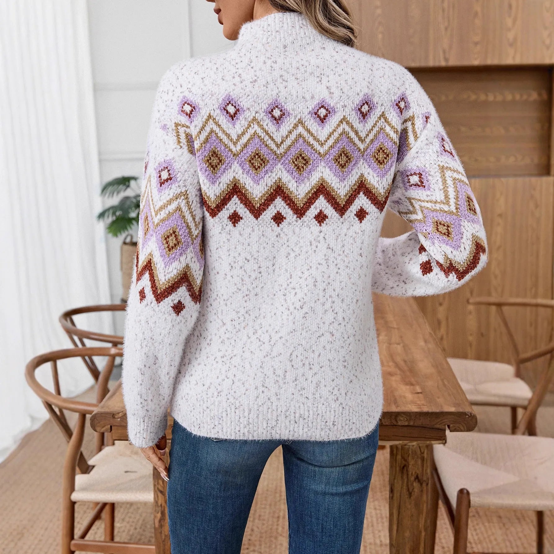 White women's sweater with geometric jacquard pattern and a half turtleneck collar.