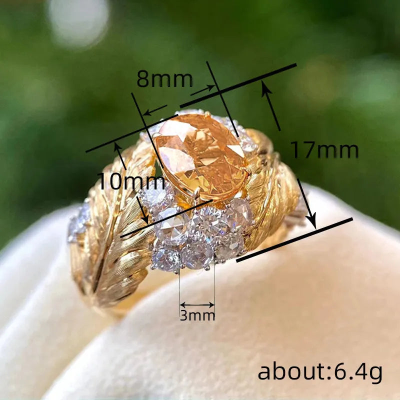 Gold coloured embossed feather ring with geometric design and yellow zircon stone inlays