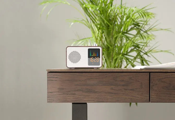 Brown woodgrain retro-style Bluetooth speaker with FM radio dials and a front fabric grille.