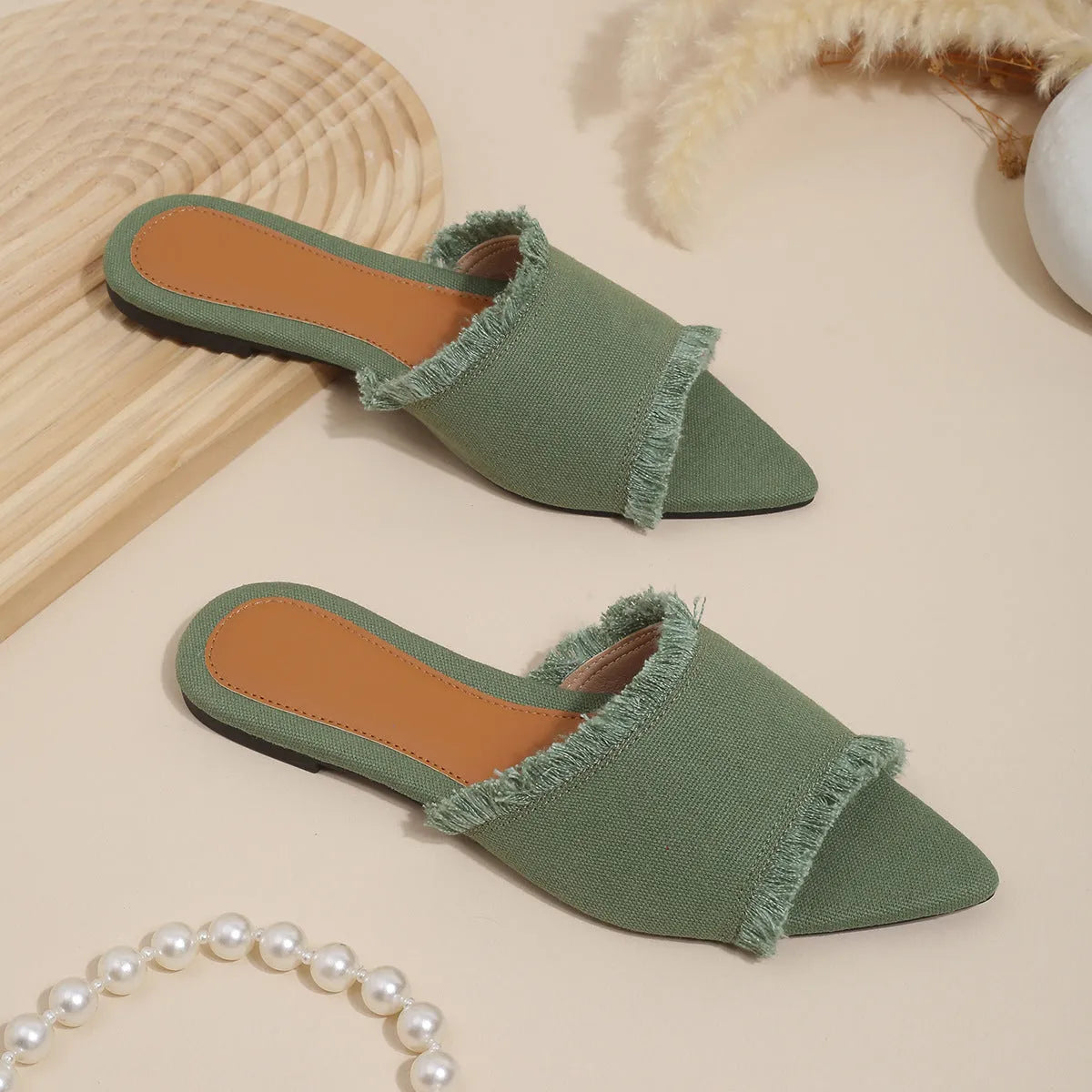 Women's denim casual flat slippers with a tassel detail in multiple colour options.