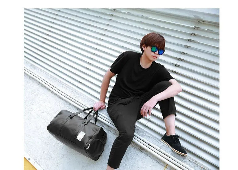 Black waterproof sports fitness bag with diagonal straps and separate internal shoe compartments.