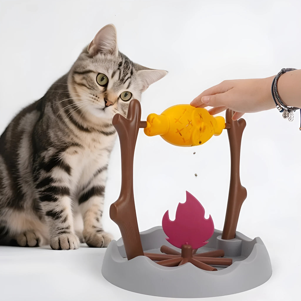 Barbecue-shaped plastic cat feeder toy for dispensing dry kibble during play.