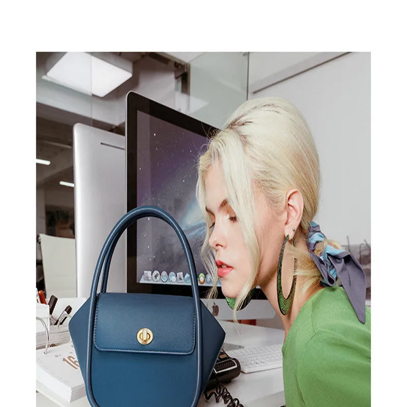 Women's leather wing-shaped tote bag with hard handle and cross-body strap in four colour options