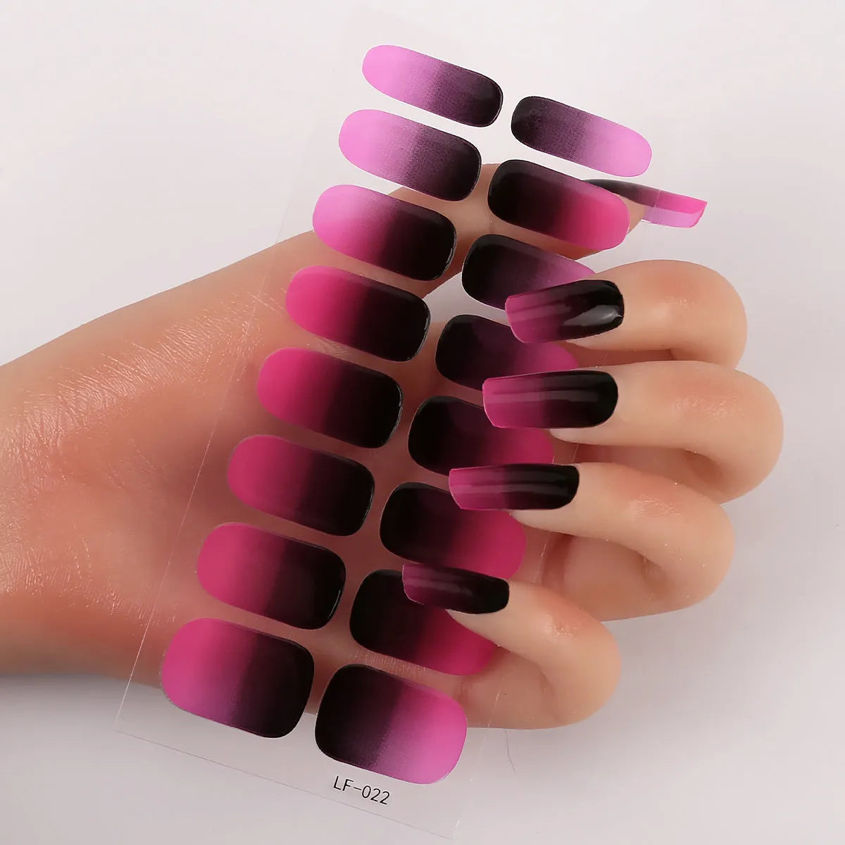 Set of 16 solid colour nail art stickers showing floral, geometric, and pattern designs for manicure application
