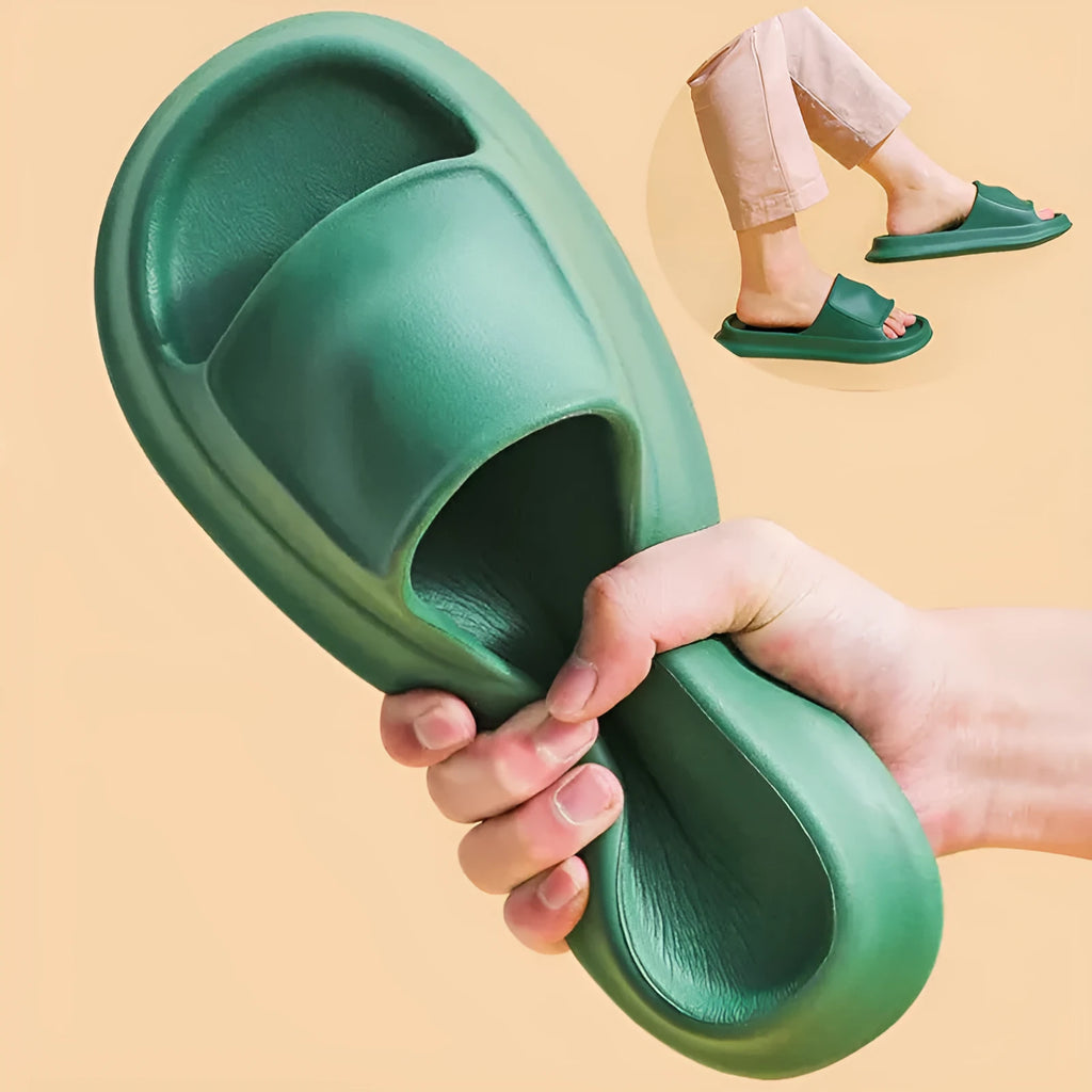 Pair of thick-soled white EVA foam flip-flop slippers on a bathroom floor, showing non-slip tread pattern.