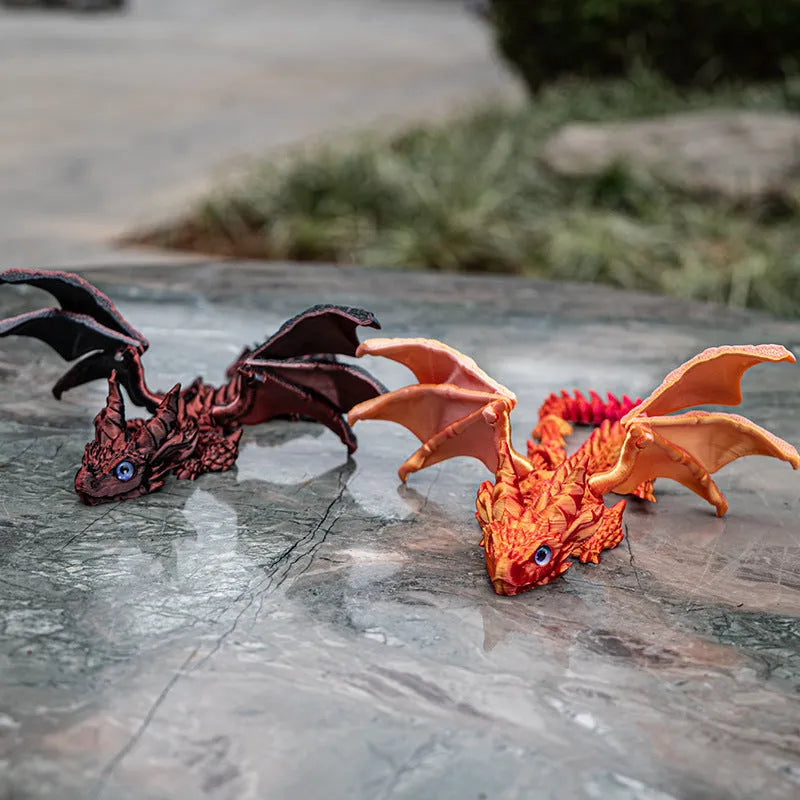 Red and gold 3D printed dragon wings toy decoration on a white background.