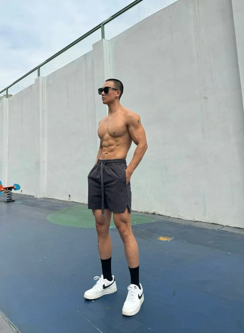 Man wearing grey ice silk quick-drying double-layer quarter shorts on a casual day out.