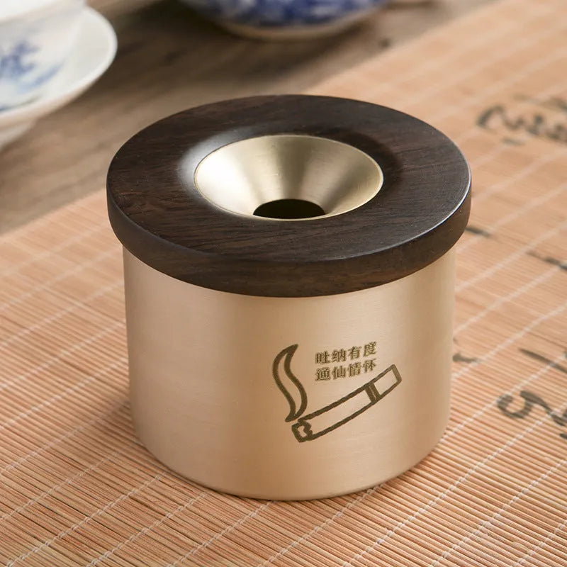 Retro brass ashtray with wooden lid showing copper construction and central hole design