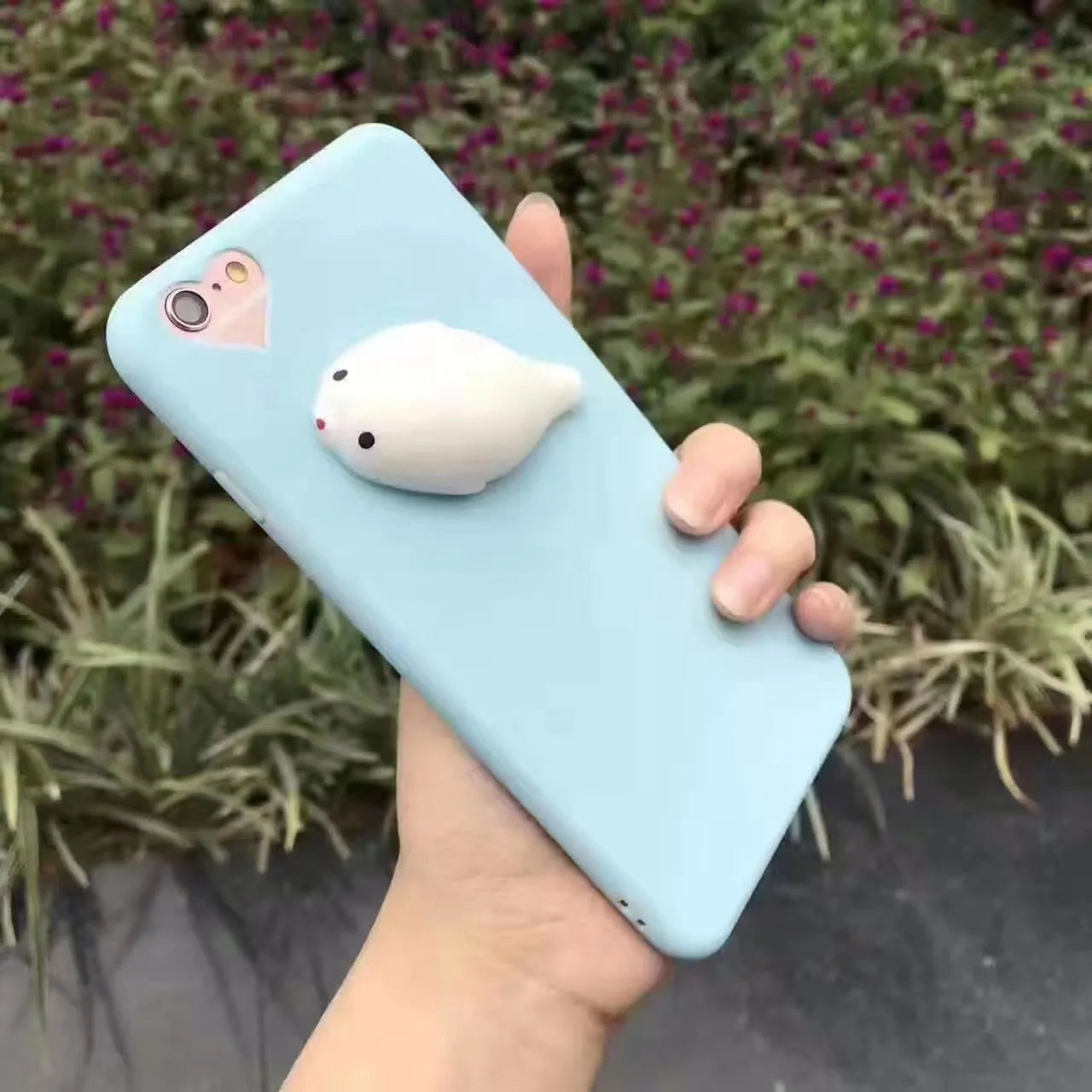 Soft silicone TPU iPhone case with a raised 3D cartoon cat design, shown in various colours.